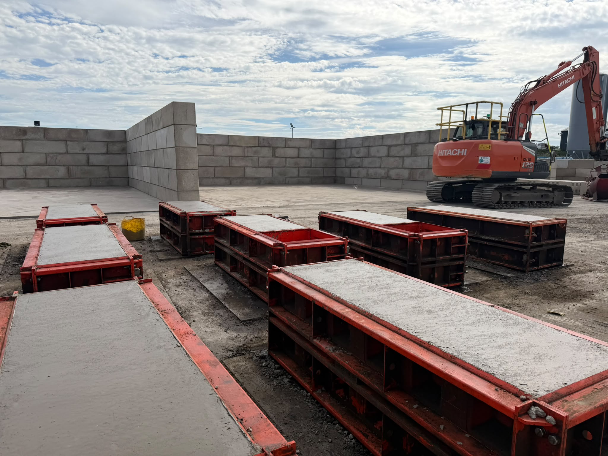 Rows of freshly filled red Beton block moulds at the Paton yard